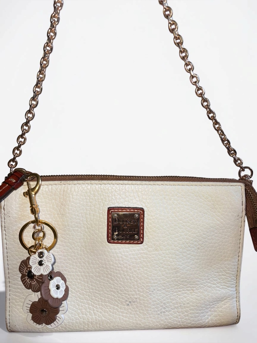 Dooney & Bourke Cream Leather Wristlet with Brown Trim and Floral Charm